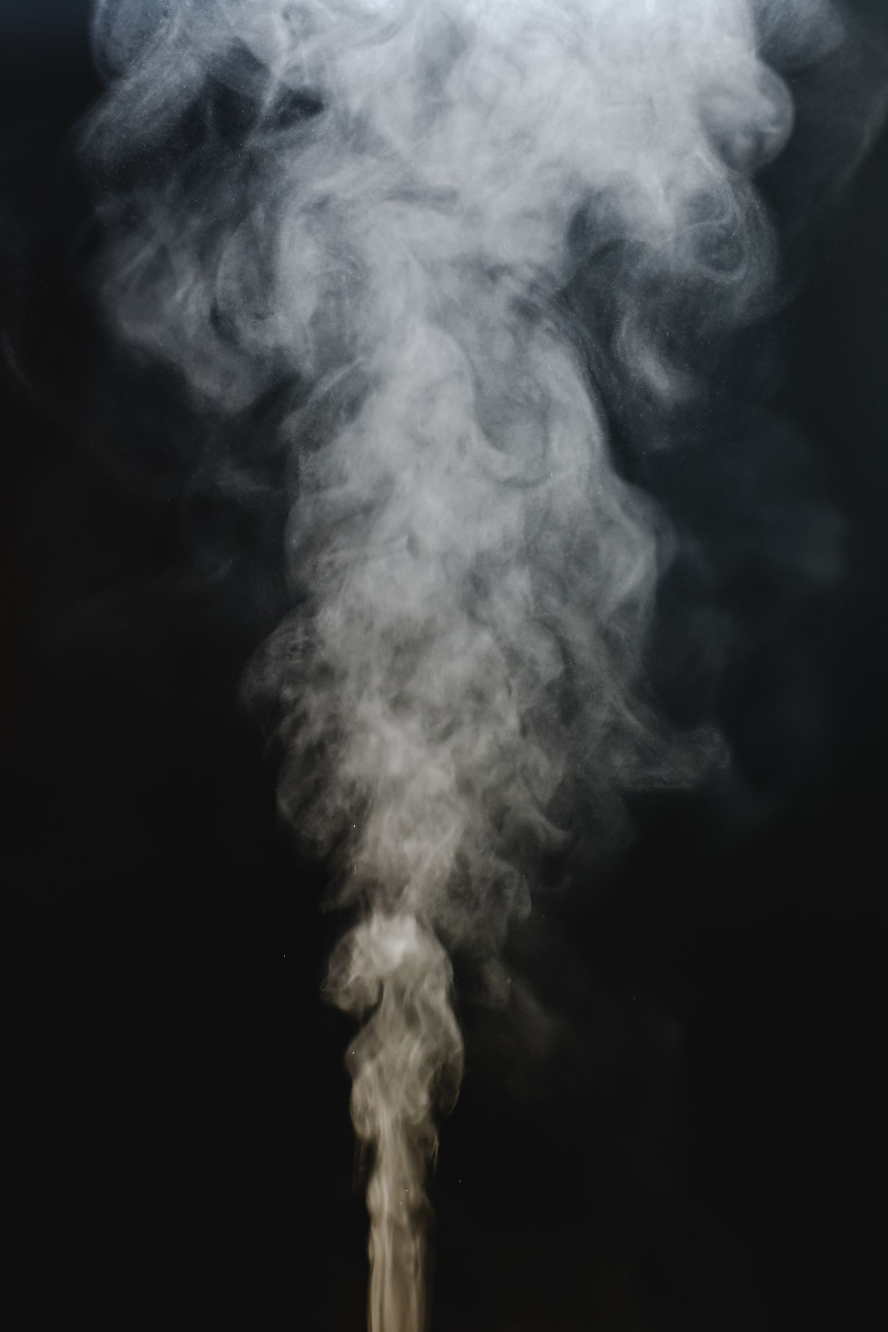 Smoke rising in darkness